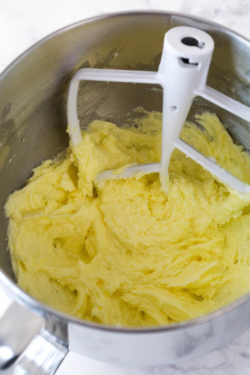 Mixing eggs and vanilla into cookie dough.