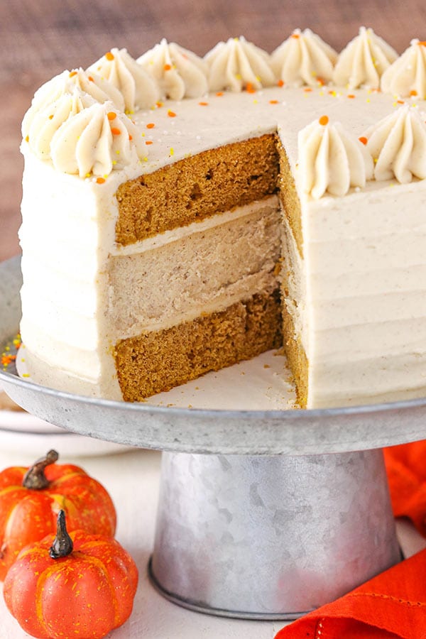 Pumpkin cheesecake cake with a slice cut out of it.
