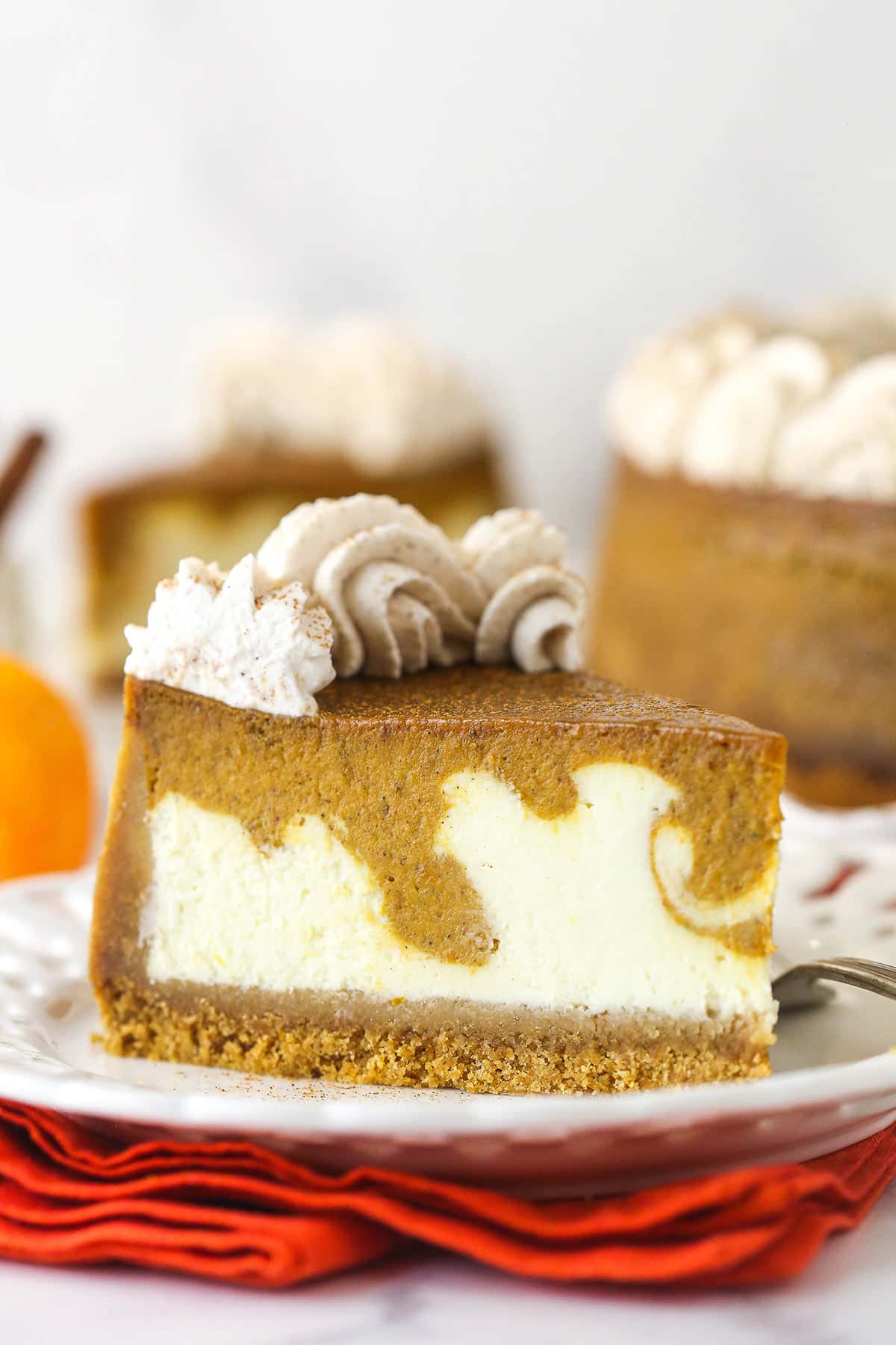 A slice of pumpkin pie cheesecake on a plate.