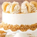 Side view of a full Snickerdoodle Layer Cake on a white cake stand